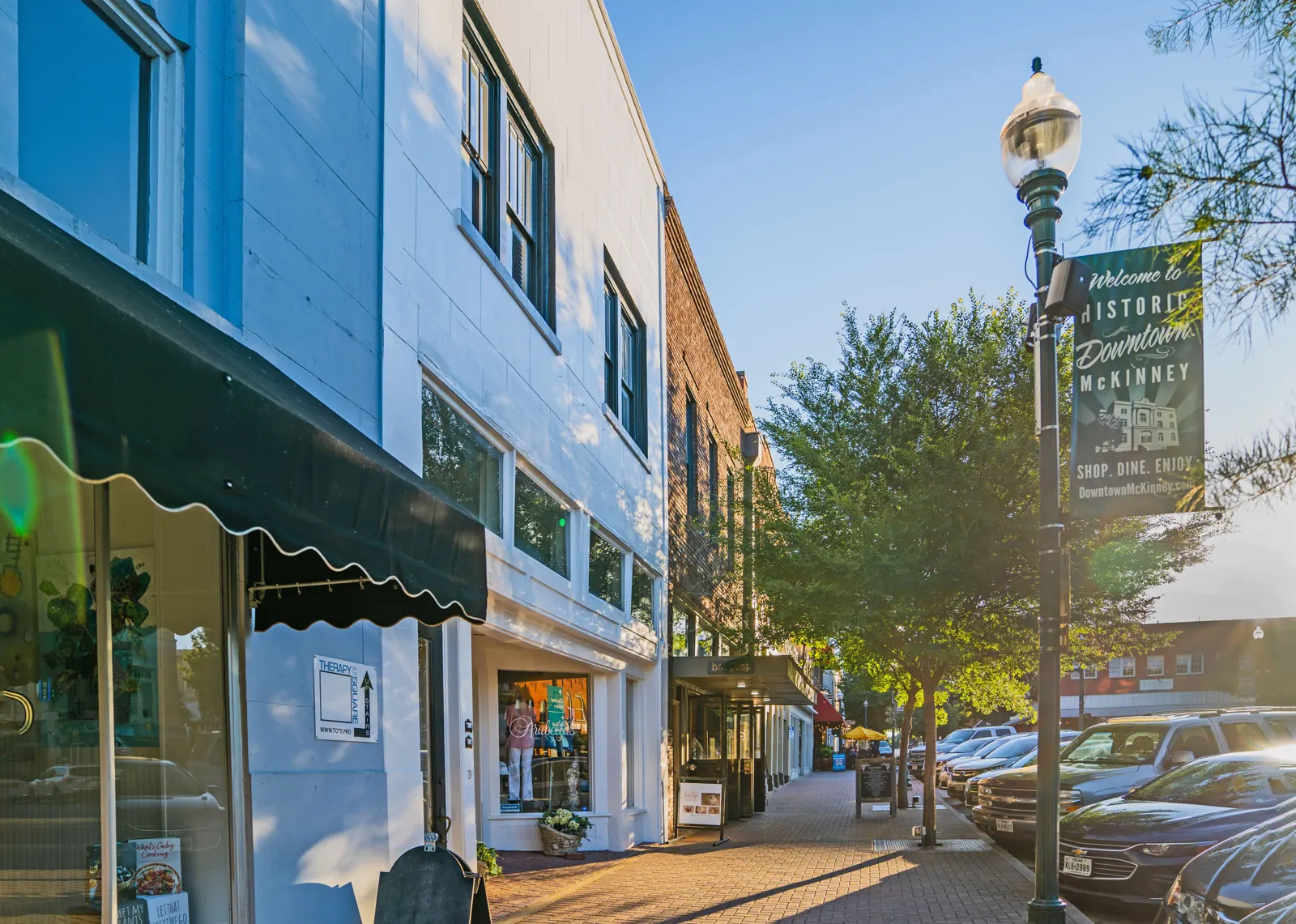 Historic downtown McKinney, Texas, along a brick sidewalk of storefronts