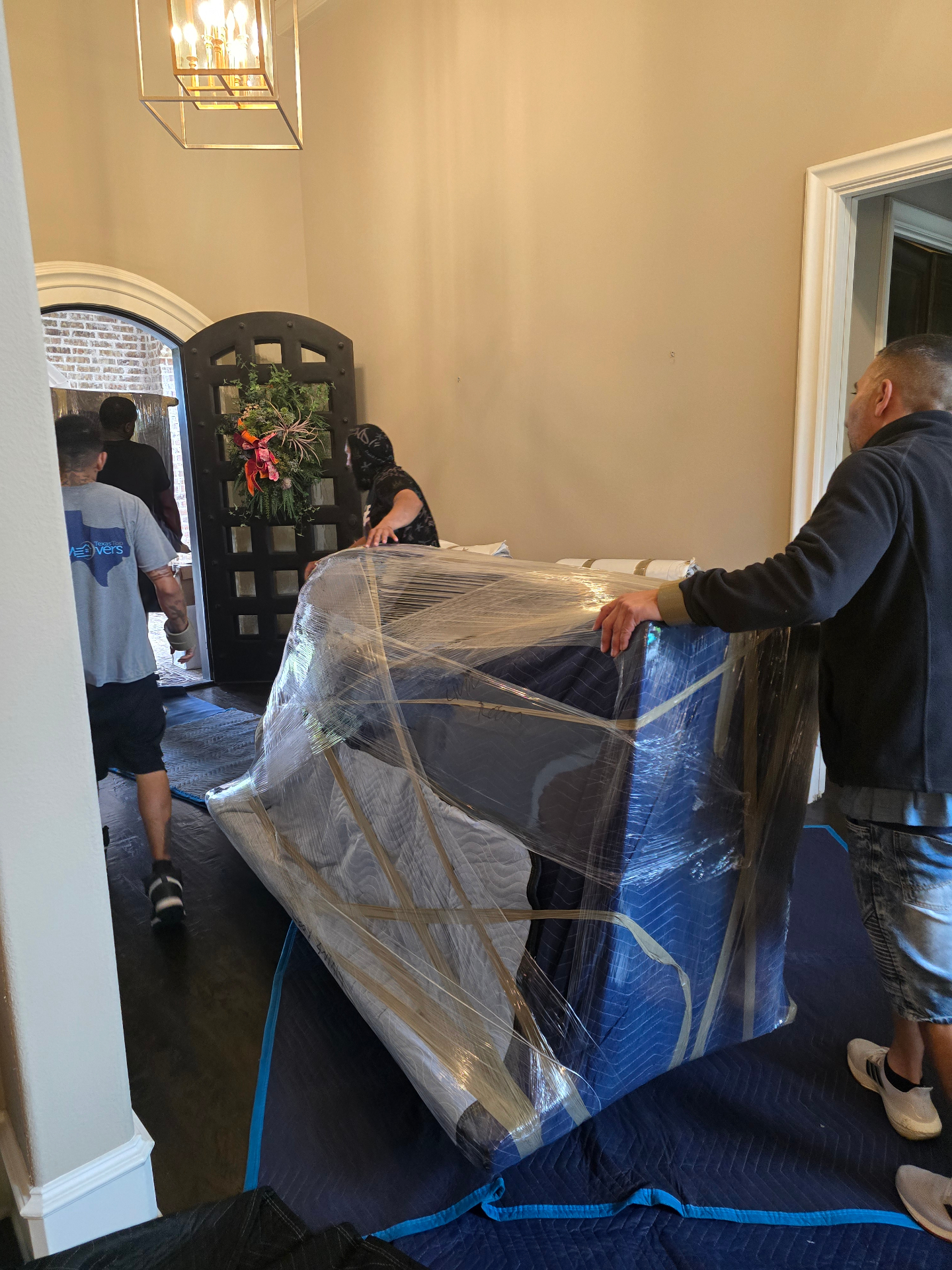 Stonebriar movers wrapping and protecting furniture in a Dallas home